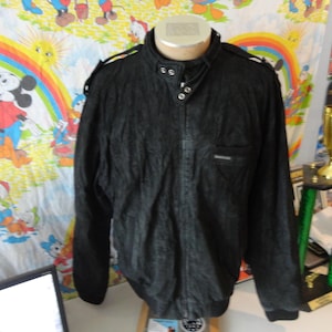 May include: Black Members Only jacket with a stand-up collar, snap closures, and a small chest pocket. The jacket has shoulder epaulets and a textured appearance. The jacket is displayed on a mannequin.