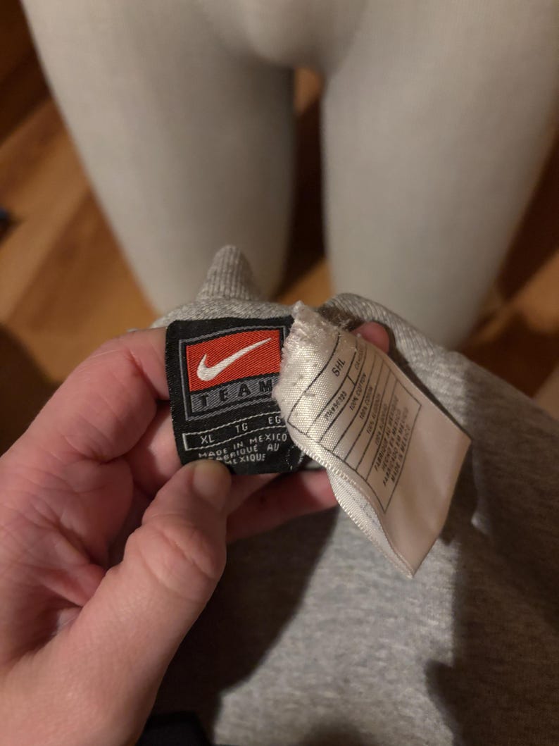 May include: Gray Nike Team sweatshirt tag with a white background. The tag shows the size XL, TG, EG, and the text "Made in Mexico" and "Fabrique au Mexique".