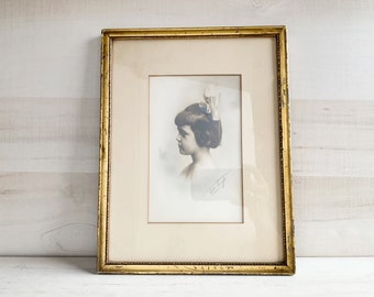 Instant ancestor sepia portrait, antique sepia photograph of a young girl with hair bow in a rustic gilt frame