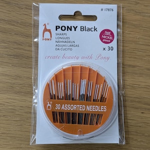 May include: A pack of 30 assorted sewing needles in a clear plastic container with an orange lid. The pack is labelled "Pony Black" and "30 Assorted Needles".