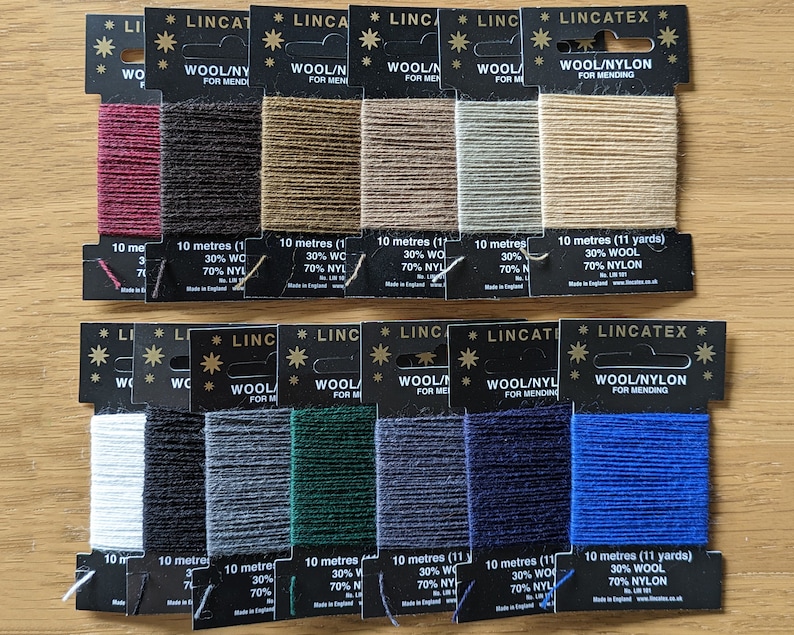 May include: Assortment of 10-meter spools of wool/nylon mending thread in various colors. Each spool is labeled with "Wool/Nylon for Mending" and the length in meters and yards. The thread is 30% wool and 70% nylon.