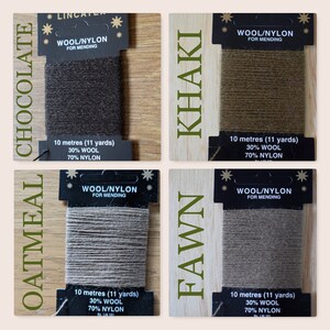 May include: Four spools of wool/nylon mending thread in the colors chocolate, oatmeal, khaki, and fawn. Each spool is labeled with the text "Wool/Nylon for Mending" and includes the length in meters and yards, as well as the percentage of wool and nylon.