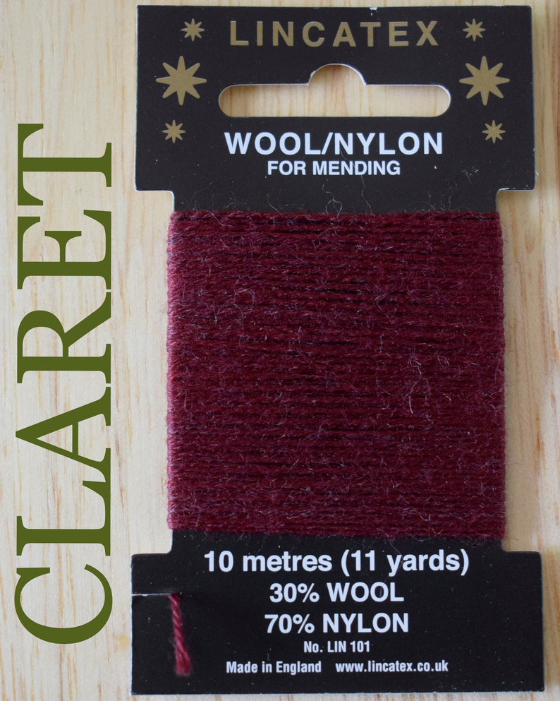 May include: A spool of claret red wool and nylon mending thread. The label reads "LINCATEX", "WOOL/NYLON FOR MENDING", "10 metres (11 yards)", "30% WOOL 70% NYLON", "No. LIN 101", "Made in England www.lincatex.co.uk".