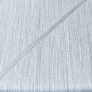 May include: Close-up of white thread, showing the texture and individual strands.