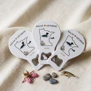 Back view of a state-shaped wedding favor revealing the heavy-duty metal bottle opener and strong magnet