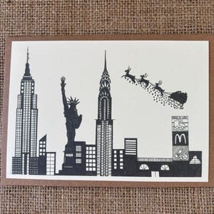 Handmade, Hand Drawn Christmas Card - New York - Featuring Santa and his Reindeer flying overhead.