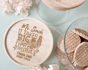May include: Two wooden lids with engraved messages. The first lid says "You are an awesome teacher. Love Indi 2023". The second lid says "Ms Sarah It takes a big heart to shape little minds. Thank you! Hugo 2023".