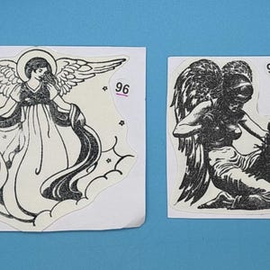 May include: Two black and white angel illustrations on white paper. The angel on the left is wearing a flowing robe and has wings. The angel on the right is holding a bird in its hand and has wings. The number 96 is printed in the top right corner of the left image and the number 97 is printed in the top right corner of the right image.