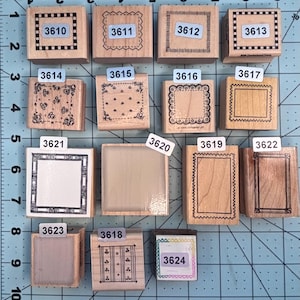 May include: A collection of wooden rubber stamps with various frame designs. Each stamp has a unique border pattern, including dotted lines, scalloped edges, and geometric shapes. The stamps are labeled with numbers like 3610, 3611, and 3612.