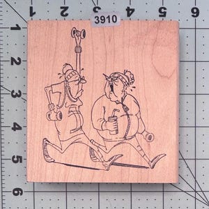 May include: Wooden stamp featuring a cartoon illustration of two people exercising. One person is running with weights, and the other is sitting with a drink. The stamp has the number "3910" on it.