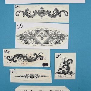 May include: A sheet of vintage iron-on transfer designs for crafts. The designs include floral patterns, a dove with a banner that says "ANT TRANSFER", and a wavy line with the text "DREAM LINK".