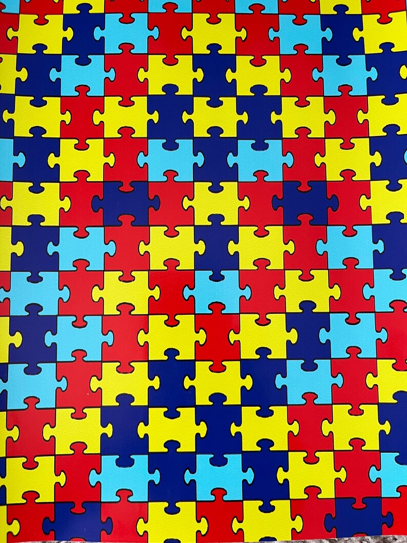 May include: A repeating pattern of puzzle pieces in blue, red, yellow, and light blue. The puzzle pieces are arranged in a grid pattern.