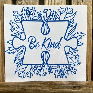 May include: Blue puzzle piece with the words "Be Kind" inside, surrounded by a border of blue flowers and leaves.