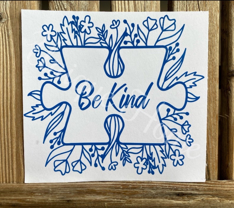 May include: Blue puzzle piece with the words "Be Kind" inside, surrounded by a border of blue flowers and leaves.