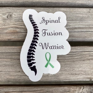 May include: White sticker with a black silhouette of a spine, a green ribbon, and the text "Spinal Fusion Warrior".