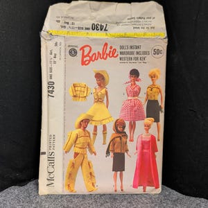 May include: Vintage McCall's printed pattern for Barbie doll clothing, featuring the official Barbie logo. The pattern includes a variety of doll outfits, including a western theme for Ken. The pattern number is 7430.