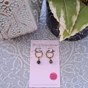 Hoop earrings with wire wrapped fresh water pearls.