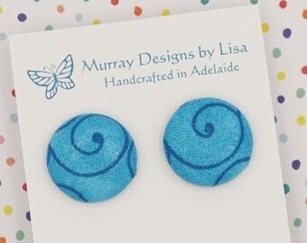 Fabric button earrings in blue with swirls.