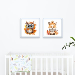 May include: Two framed watercolor paintings of woodland animals. The first painting features an owl wearing blue glasses and surrounded by orange and yellow leaves. The second painting features a fox wearing a gray scarf and surrounded by orange and yellow leaves.