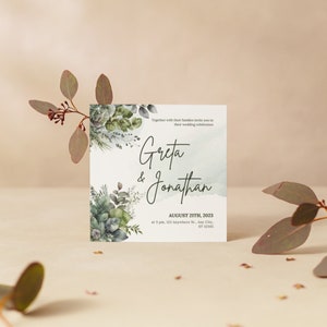 以下が含まれることがあります： 緑の葉が描かれた水彩画の背景に、「Greta & Jonathan」の文字と、「August 21th, 2023」の日付、「123 Anywhere St. Any City, ST 12345」の場所が書かれた結婚式の招待状です。