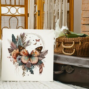 May include: A white canvas print with a watercolor painting of a butterfly with brown, orange, and yellow wings. The butterfly is surrounded by flowers and leaves in shades of pink, red, and green.