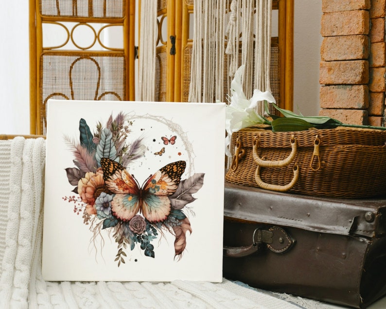 May include: A white canvas print with a watercolor painting of a butterfly with brown, orange, and yellow wings. The butterfly is surrounded by flowers and leaves in shades of pink, red, and green.