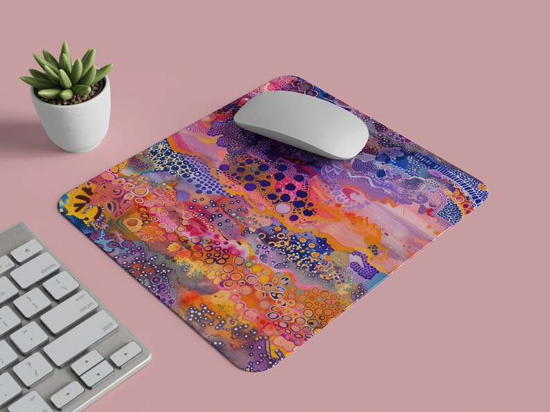 May include: A colourful abstract mouse mat with a swirling pattern of purple, orange, yellow, and blue. The mouse mat has a white computer mouse on top of it.