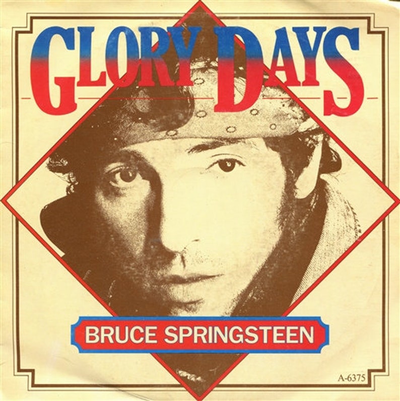 May include: A vintage record sleeve featuring a close-up portrait of Bruce Springsteen. The sleeve is red, white and blue with the title "Glory Days" in large, bold letters. The record number "A-6375" is printed in the bottom right corner.