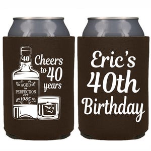 May include: Two brown can coolers with white text. One cooler says "Cheers to 40 years" with a bottle of liquor and a glass of whiskey. The other cooler says "Eric's 40th Birthday".