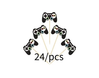 May include: A set of 24 black and white video game controller cupcake toppers with colorful buttons. The toppers are on wooden sticks.