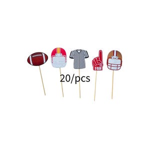 May include: A collection of football-themed cupcake toppers. The toppers include a football, helmets, a referee shirt, and a foam finger with the word "FAN". The text "20/pcs" is also included.