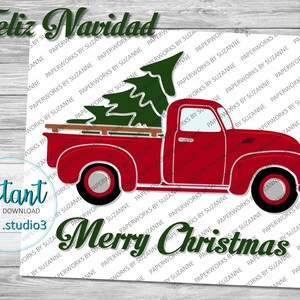 May include: Red vintage pickup truck with a green Christmas tree in the bed. The truck has a white background with the words "Feliz Navidad" and "Merry Christmas" in green.