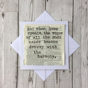 May include: A vintage-style card with a black heart and text from Shakespeare's Love's Labour's Lost. The text reads "And when love speaks, the voice of all the gods makes heaven drowsy with harmony."