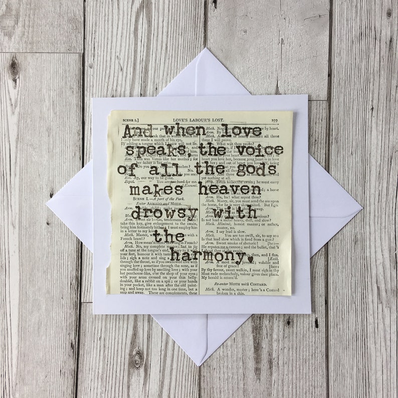 May include: A vintage-style card with a black heart and text from Shakespeare's Love's Labour's Lost. The text reads "And when love speaks, the voice of all the gods makes heaven drowsy with harmony."