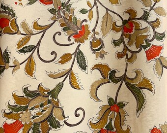 May include: A white fabric with a repeating pattern of brown and green floral designs. The flowers have red centres.