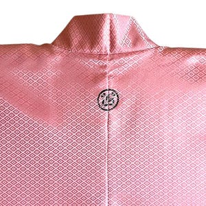 May include: A pink kimono with a white diamond pattern and a black crest on the back.