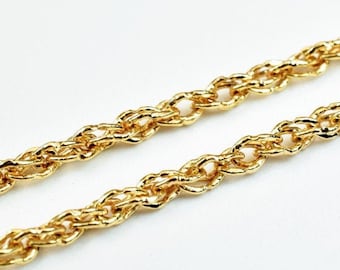 May include: A gold rope chain necklace. The chain is made of small, linked, twisted pieces of metal.