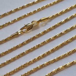 May include: A gold chain necklace with a lobster clasp. The chain is made of a twisted rope design.