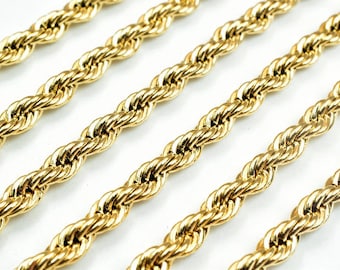 May include: Close-up of a gold rope chain necklace. The chain is made of thick, interwoven links, creating a textured and luxurious look.