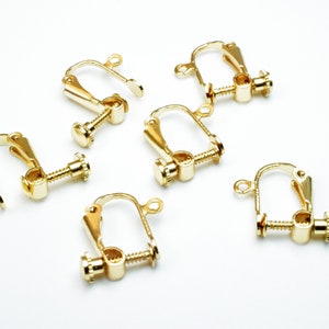 May include: Six gold-tone earring clips with a screw-on back. The clips are designed to hold earrings in place for those with sensitive ears.