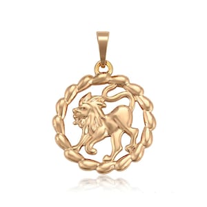 May include: Gold-toned pendant featuring a detailed lion design within a circular frame. The pendant is a zodiac symbol for Leo.