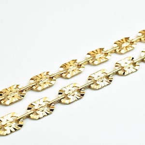 May include: A gold chain necklace with a textured, oval-shaped link design.