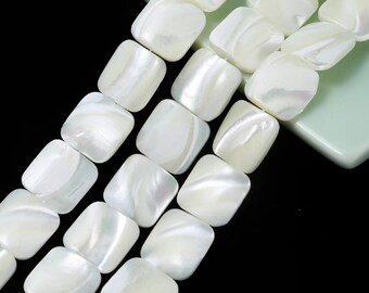 May include: A strand of white square-shaped shell beads. The beads have a pearlescent finish and are strung together on a clear thread.