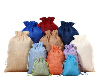 May include: A set of 11 burlap drawstring bags in various colors, including beige, blue, green, red, and orange. The bags are arranged in a pyramid shape, with the largest bag at the bottom and the smallest bag at the top.