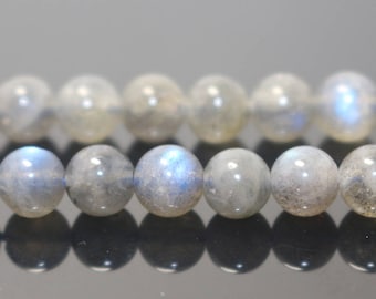 May include: A strand of iridescent gray labradorite beads. The beads are round and smooth, with a subtle shimmer.