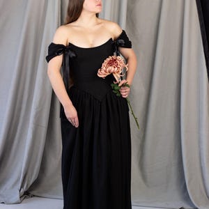 black medieval dress with corset waist and flowing skirt