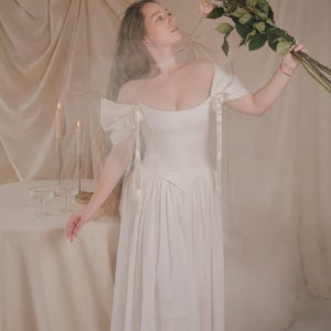flowy ivory bridal dress with corset bodice romantic renaissance wedding gown in motion