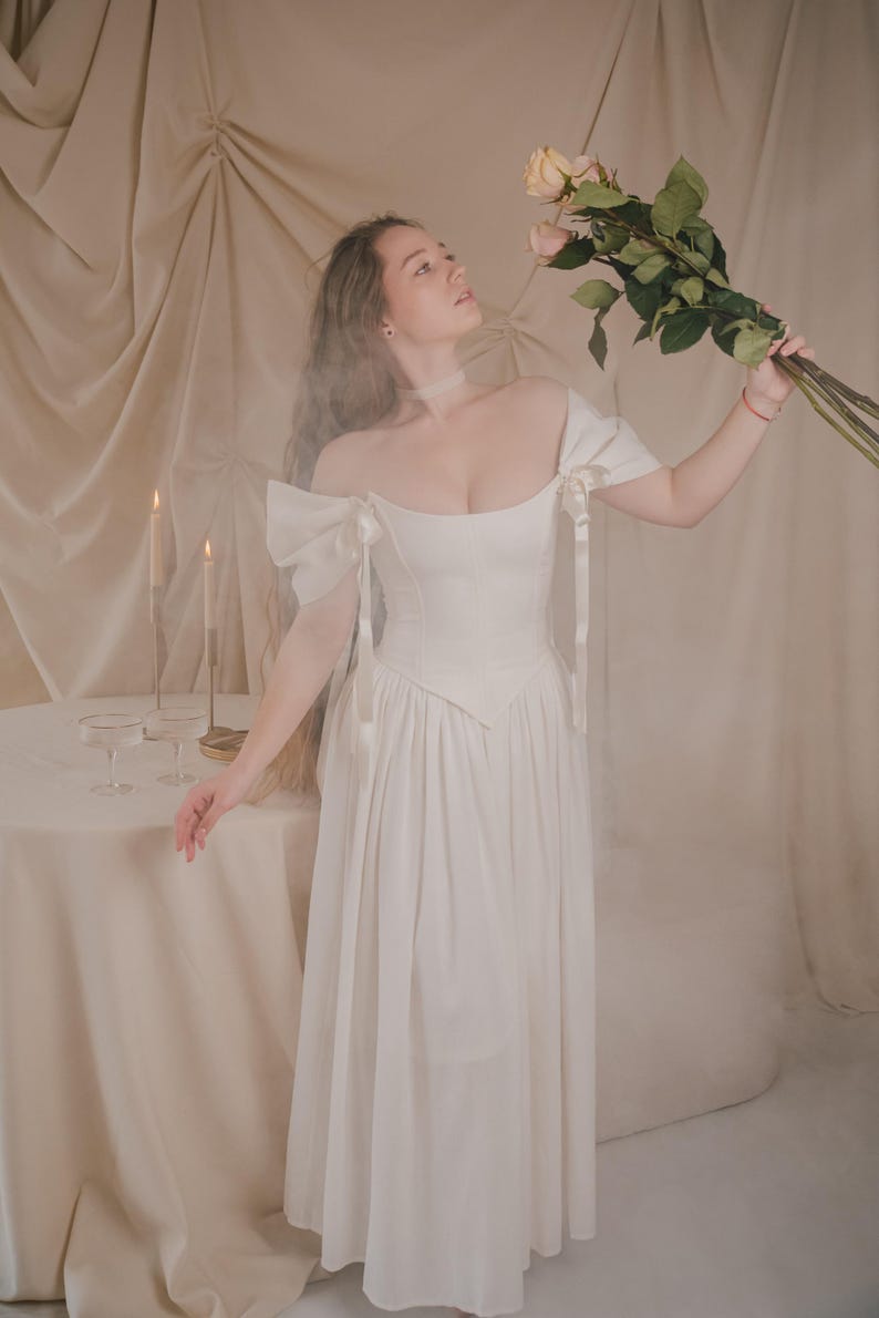 flowy ivory bridal dress with corset bodice romantic renaissance wedding gown in motion