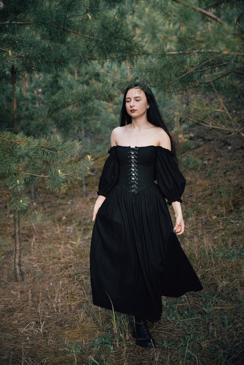 Renaissance style black dress with corset bodice, dramatic sleeves and flowing skirt