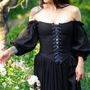 Off the shoulder black linen dress with structured corset, flowing skirt and puff sleeves